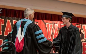  Canyon Echerd (left) shaking hands with CVCC President Dr. Garrett Hinshaw. 