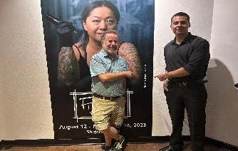 Joe Young and Pablo Becerrill stand in front of exhibit