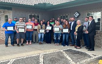 Supervisor Certification Graduates standing with certificates after graduation ceremony