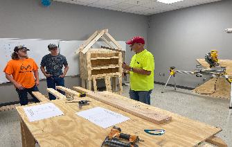 Construction Academy students build wiring booths for new Sustainability Technology course